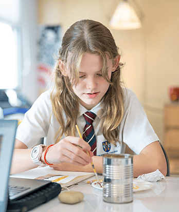 A Brighton College Vibhavadi senior pupil showing curiosity while creating artwork in class
