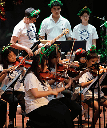 Brighton College Vibhavadi pupils performing classical music on stage, showcasing confidence and musical discipline at a top international school.