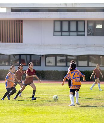 Pupils playing football at Brighton College Vibhavadi, strengthening collaboration and determination through sport.