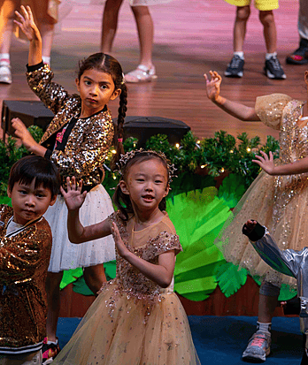 Pupils from Brighton College Vibhavadi performing a group piece on stage, highlighting creative arts in a top British curriculum school.