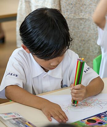 Pupil coloring during a creative activity at Brighton College Vibhavadi, supporting artistic expression beyond the classroom in a premium international school in Thailand.
