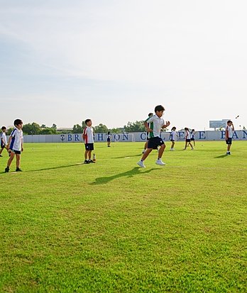 Pupil playing football at Brighton College Vibhavadi, where every child takes part in inclusive and enjoyable sport for all.