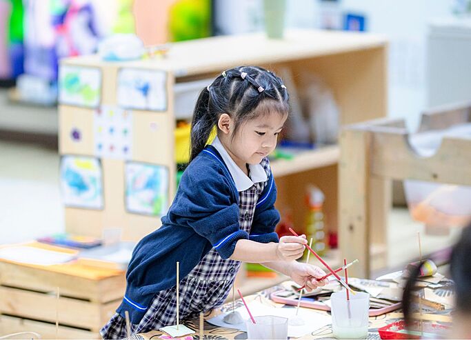  Pupil creating artwork in Art Club at Brighton College Vibhavadi, where creativity is nurtured through engaging co-curricular programmes. 