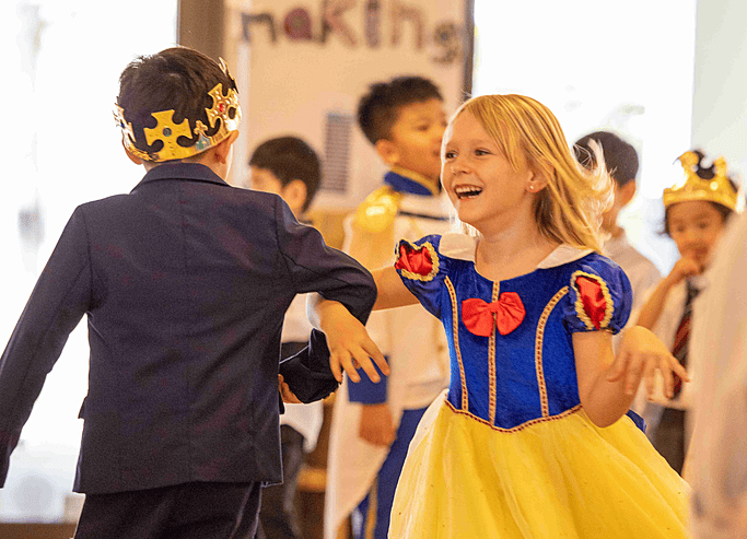  Pupil performing in a Snow White costume at Brighton College Vibhavadi, part of a themed stage show celebrating creative learning. 
