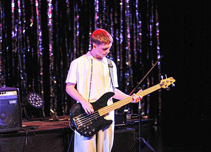  Brighton College Vibhavadi pupil performing a solo guitar piece, building confidence through performing arts education. 