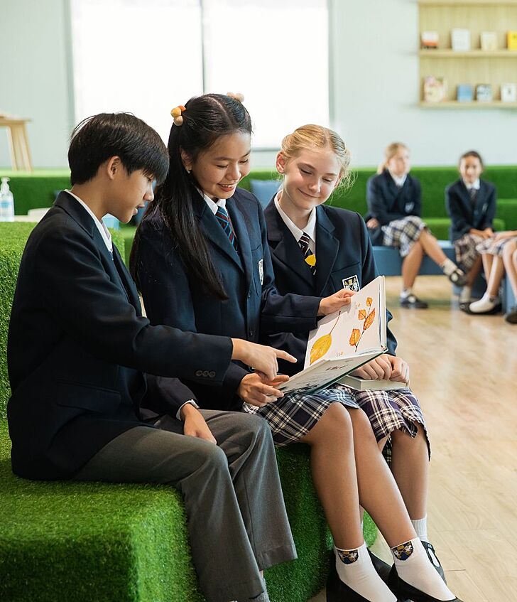  Senior pupil chatting with Early Years children at Brighton College Vibhavadi. 