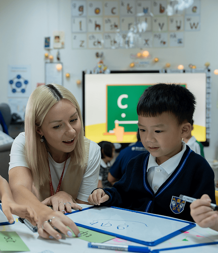 Teacher guiding pupils in class at Brighton College Krungthep Kreetha, inspiring a love of learning through engaging British curriculum lessons. 