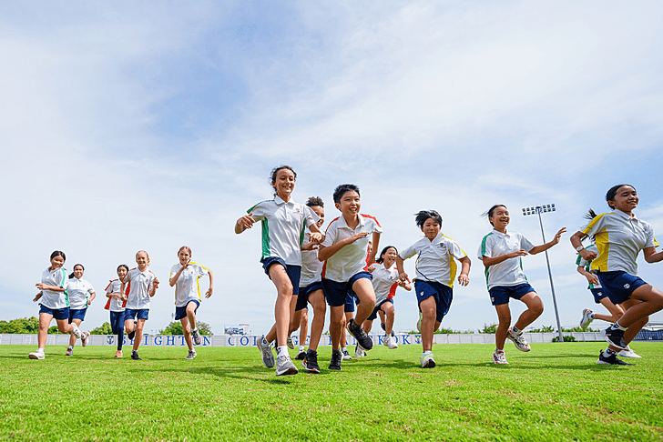  Brighton College Vibhavadi senior pupils run in the football field with happy face 