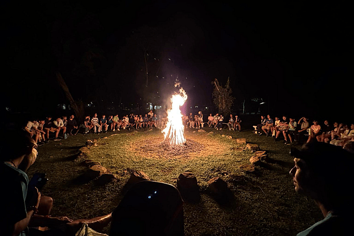  Brighton College Vibhavadi pupils sitting around a campfire during an outdoor learning experience at one of the best international schools in Thailand. 