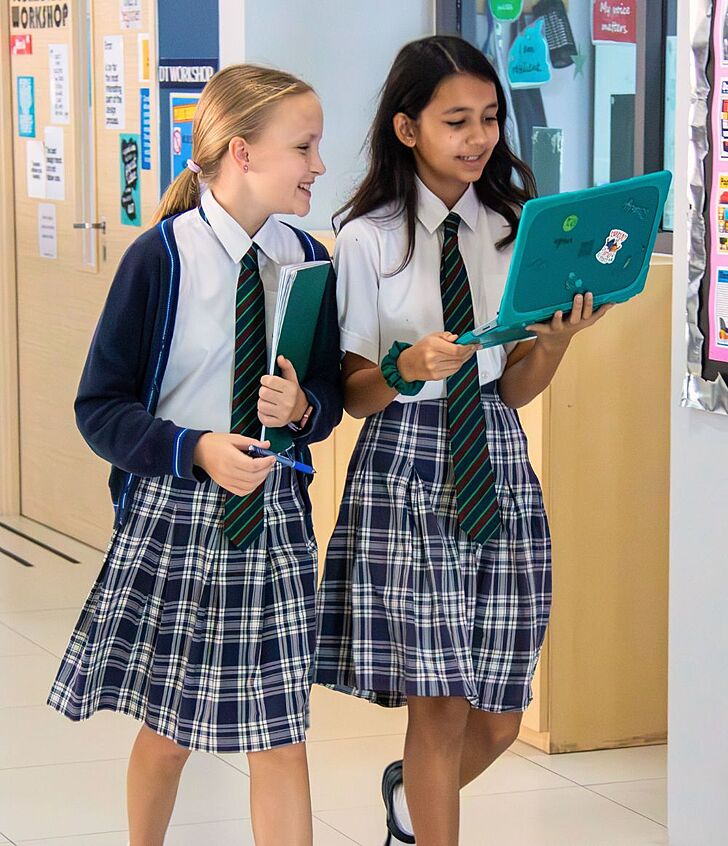  Two pupils walking with a laptop at Brighton College Vibhavadi, symbolising innovation and future-ready learning in a British curriculum school. 
