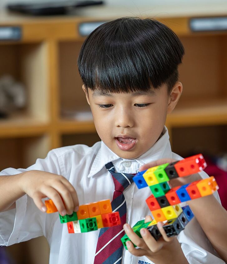  Nursery pupils playing with Lego blocks at Brighton College Vibhavadi, developing imagination and problem-solving through guided play. 