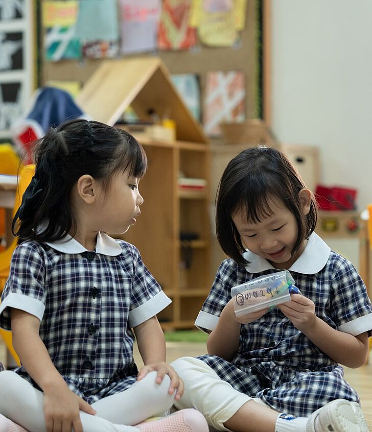 Three pupils sitting together in class at Brighton College Vibhavadi, part of a collaborative and engaging international school environment. 