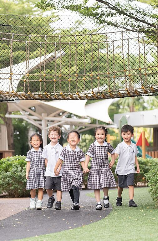  Five pupils walking joyfully in the Early Years playground at Brighton College Vibhavadi, where young learners thrive in a nurturing international school environment. 